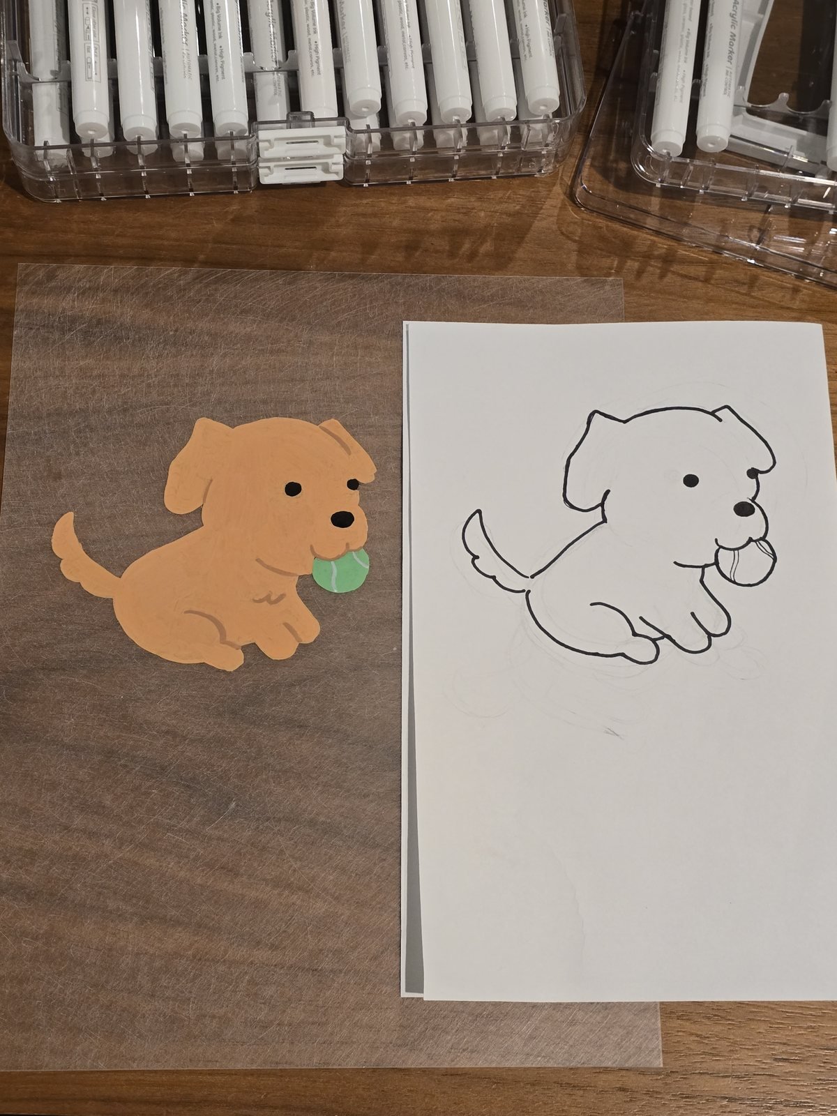 The cut, colored shrink-plastic piece next to the original blank sketch it was traced from